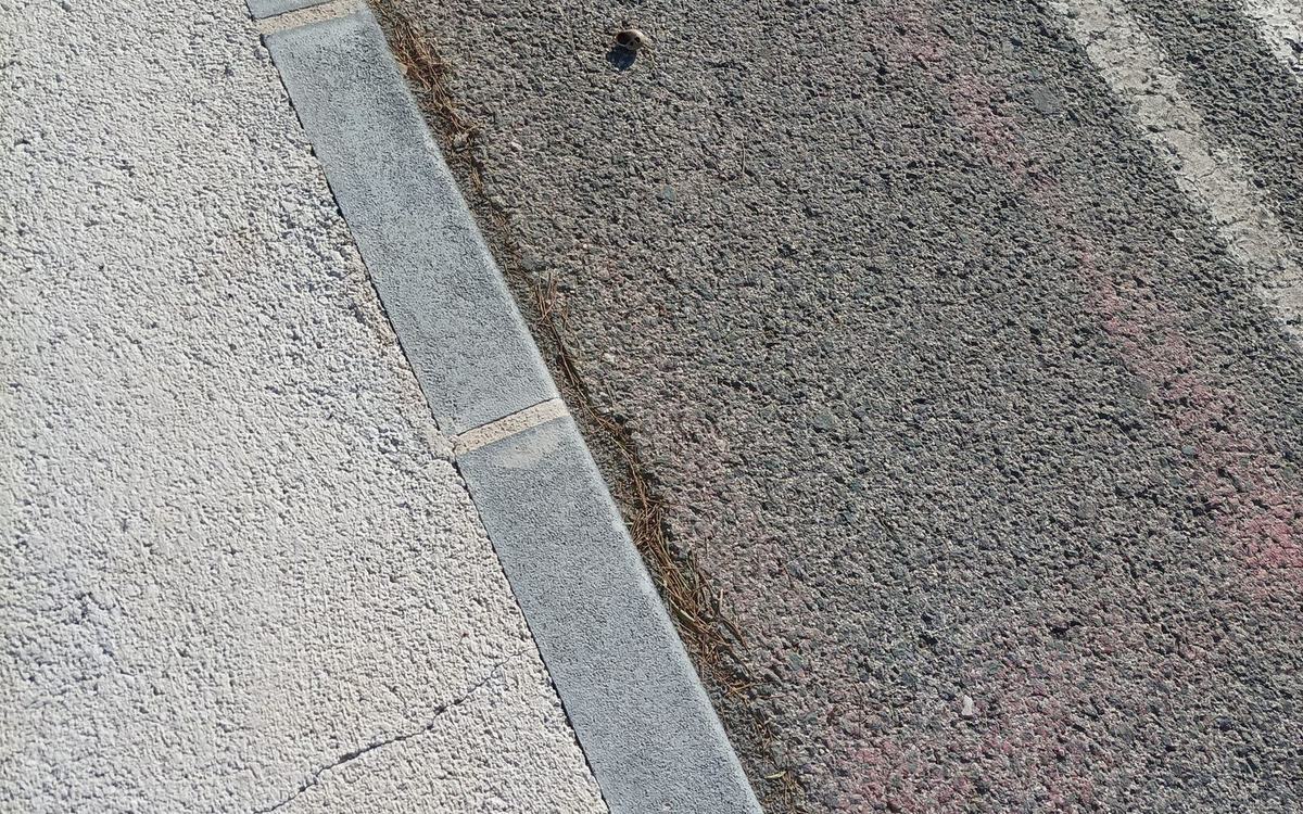 Concrete kerb line separating a footway from a road